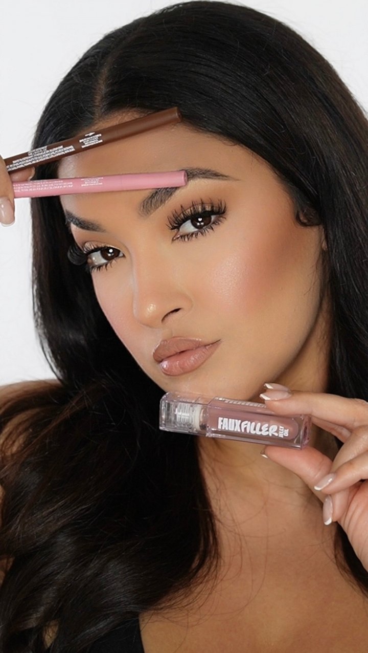 Bianca posing with the lip liners and gloss, labels readable